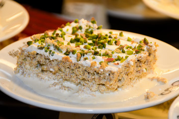 Turkish Traditional Ramadan Dessert Gullac with grated pistachio on top which made with milk