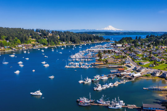 Beautiful Day In The Northwest Of A Harbor Town With Boats And Mt Rainier