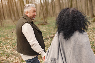 Seniors in a forest. People walks. Family with spring's flowers.