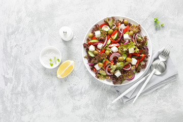 Fototapeta na wymiar Greek salad with fresh vegetables, lettuce and feta cheese