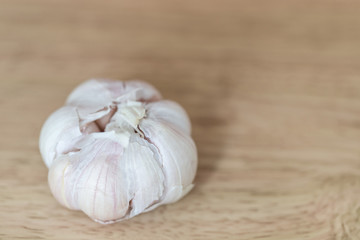 Organic bulb of garlic on a wooden cutting board