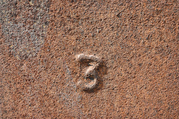 Rusty iron background with number 3 on it
