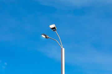 Modern street led lighting pole on blue sky background. Urban electric power technologies. Saving on street city road lighting