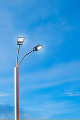 Modern street led lighting pole on blue sky background. Urban electric power technologies. Saving on street city road lighting
