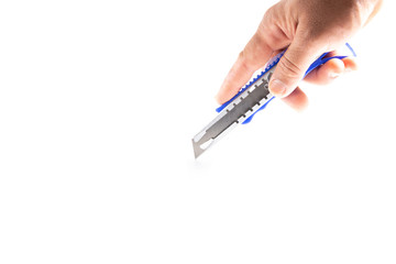 Hand holding cutter on white background.