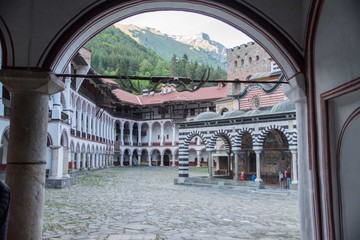 View of Rila monastery and the mountains from the entrance archway.