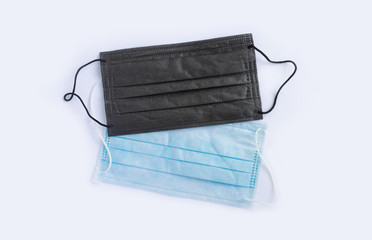 A pair of sterile medical masks in black and green.