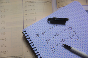 Naklejka na ściany i meble Image of a math exercise book with a pen and a textbook