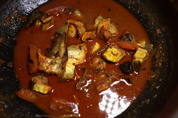 Spicy kerala style fish curry in clay pot.