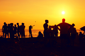 Beach Party.Silhouettes of teenagers at sunset in the evening.Bachelorette party on the coast.cheerful teenagers gathering on the beach at dusk.Silhouettes of teenagers at sunset on the beach.