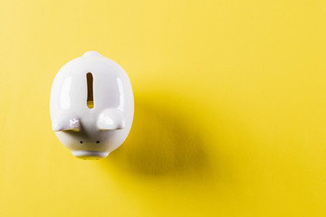 Saving money, Business Finance concept. Cute white piggy bank on yellow background.