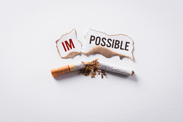 World No Tobacco Day concept, May 31. Quitting smoking or No smoking sign made with broken cigarettes on white background.