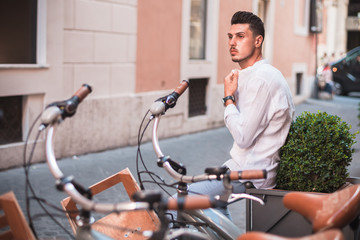 Fototapeta na wymiar Nice boy posing in Rome during a sunny day untile the sunset