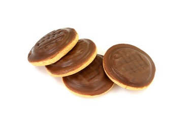 Chocolate coated biscuit cakes with the orange filling isolated over the white background.