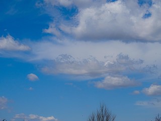 Sky blue sky with white puffy clouds.