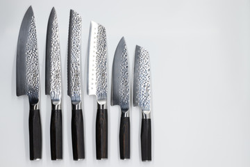 Japanese damascus kitchen knifes on the white backround © Szabina