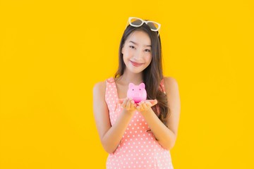 Portrait beautiful young asian woman show a lot of cash or money with piggy bank