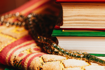 Islamic Holly Book and praying beads on mat prayer oriental style