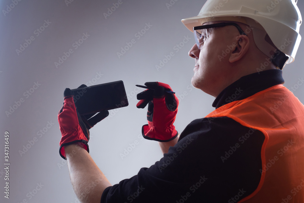 Poster applications for builders. concept - builder makes purchases via phone. human with a smartphone and 