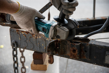 worker using a metal grinder machine