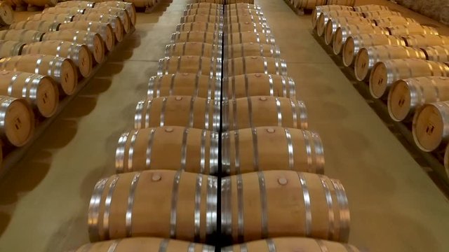 Aerial Drone close-up of wooden wine barrels in cellar
