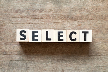 Fototapeta premium Letter block in word select on wood background