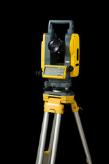 theodolite or total positioning station on tripod. land surveyor equipment. isolated on black background