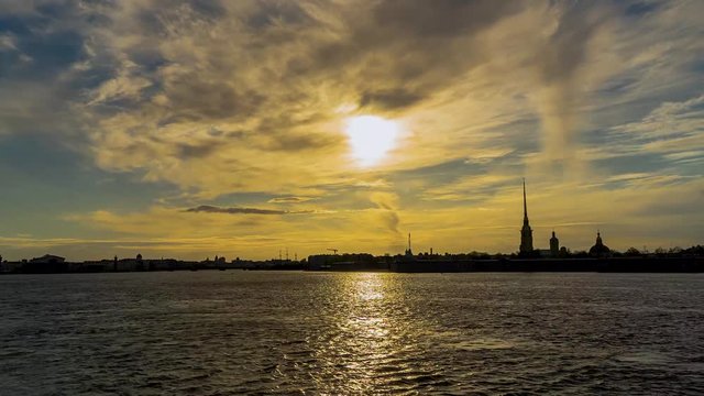Russia, Saint Petersburg, Peter and Paul fortress and the Neva river at sunset in spring. Urban landscape. Time Lapse.