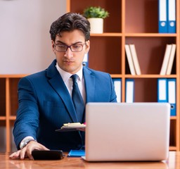 Fototapeta premium Young handsome businessman working in the office