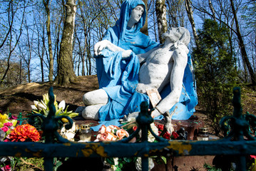 
Religious sculpture showing the figure of Mary holding Jesus after being removed from the cross in the park.