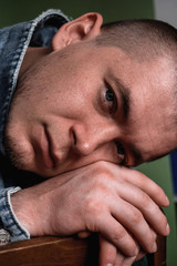 Naklejka premium facial expressions. sadness in the eyes. close-up. guy with beautiful eyes