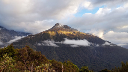 mountain landscape with clouds in the morning - Routeburn track, Fiordland National Park, New Zealand