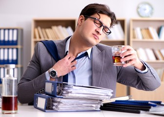 Young businessman drinking from stress