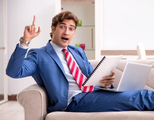 Young businessman working at home sitting on the sofa