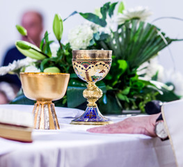 chalice with wine, blood of christ, and pyx with bread, body of christ, ready for the communion of the faithful