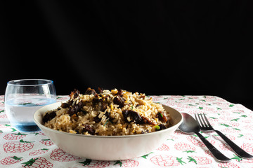 A plate of fried rice with beef and mushroom served on a table in a restaurant