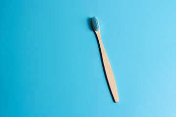 wooden toothbrush on a blue background