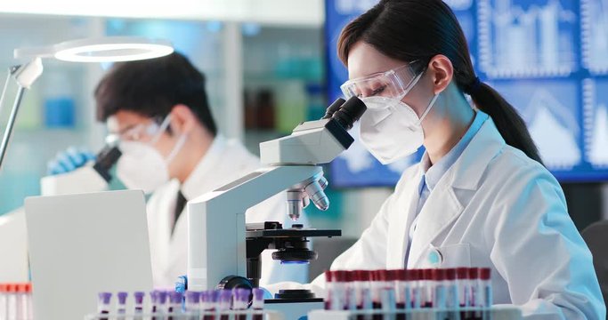 woman scientist use microscope