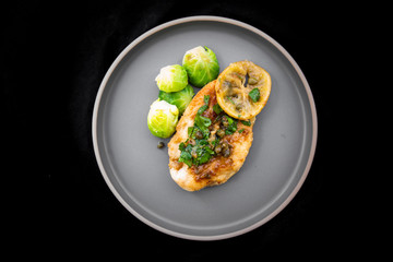 Italian food Lemon chicken Piccata  with Brussels Sprouts