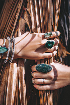 close up of woman hands with with gem stones accessories outdoors