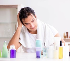 Young handsome man in the bathroom in hygiene concept
