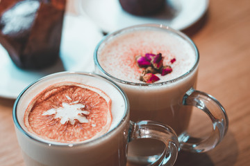 cappuccino decorated with flowers and oranges