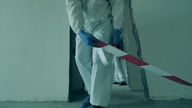 Sanitize workers restrict area for disinfection during pandemic.