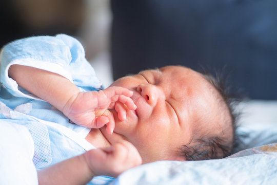 The Newborn Baby infant crying face and slepp on the bed