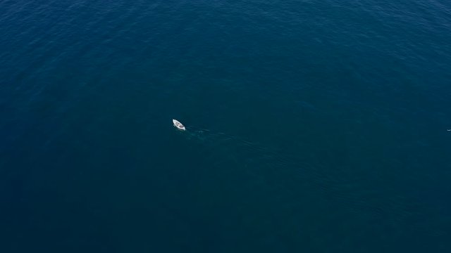 High-angle shot of a white boat on the blue sea in Athens. Aegean Sea in Greece