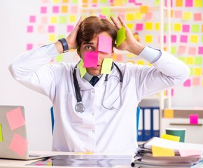 Male doctor with many conflicting prioritites
