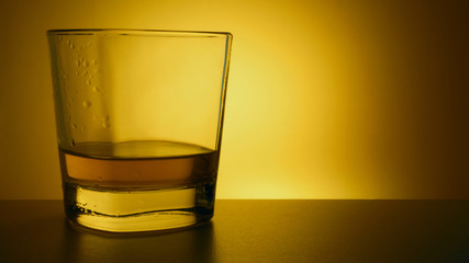 glass of whiskey in the backlight