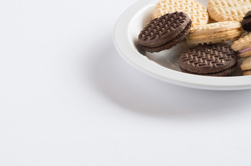 Assorted cream cookies and biscuits sitting on a plate
