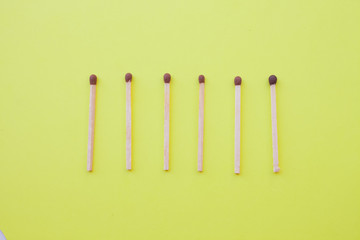 Row wooden matches yellow background,broken whole matches. Distinctive feature,broken...