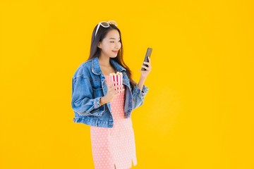 Portrait beautiful young asian woman enjoy happy with phone popcorn and watch movie